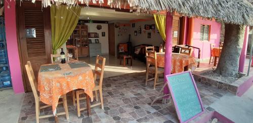 a restaurant with a table and chairs and a sign at Villa Rosa in Punta Rucia