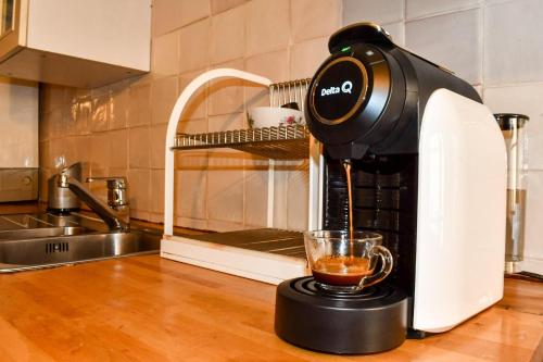 a coffee maker on a kitchen counter with a cup of coffee at Casa D’ Santiago in Monsaraz