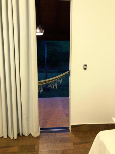 an open door to a room with a window at Paraíso Capitólio Suítes Pousada in Capitólio