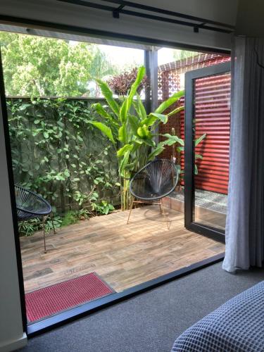 a room with a glass door leading to a patio at thespaceperth in Perth