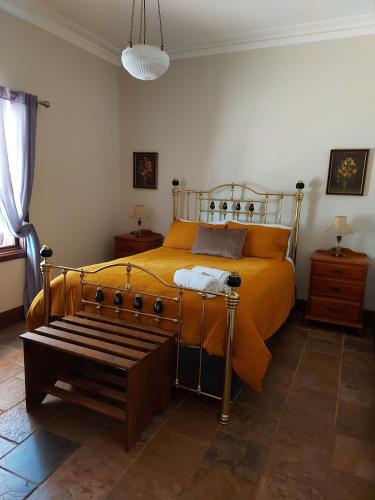 a bedroom with a bed and a bench in it at York Cottages and Burnley House in York