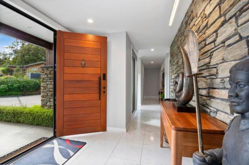 a entrance to a home with a statue of a bust at River View Retreat - Taupo in Taupo