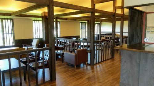 a dining room with wooden tables and chairs at FUTO HOUSE -Ippon no Enpitsu- in Ito