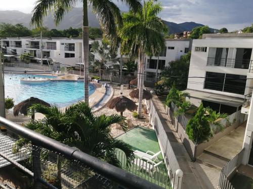 a view of the pool from the balcony of a resort at Apartasol Santafe de Antioquia in Santa Fe de Antioquia