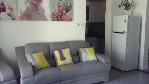 a living room with a couch and a refrigerator at Apartment Treasure at Sandcastles in Ocho Rios
