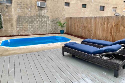 a patio with two chairs and a swimming pool at Historic home with heated Mini Pool walking distance to downtown San Antonio! in San Antonio