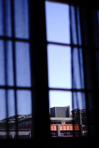 a view of a building through a window at The Intrepid Hotel in Wellington