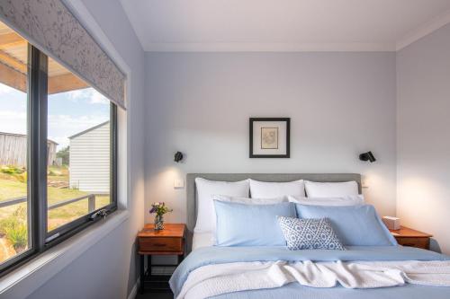 a bedroom with a bed and a window at Manna Hill Farm in West Kentish