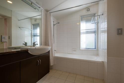 łazienka z wanną, umywalką i wanną tubermottermott w obiekcie 7 Conical Hill Road - Garden Studio 354 w mieście Hanmer Springs