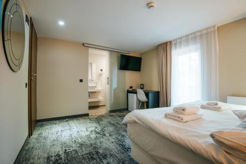 a hotel room with a bed with towels on it at Vila Fabesca in Sovata