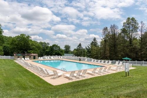 Mount Airy的住宿－Spring Gulch Screened Park Model 7，一个带躺椅和一系列设施的游泳池