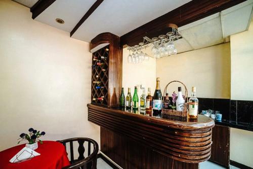 a bar with a bunch of bottles of wine at RedDoorz near Ormoc Port Terminal in Ormoc
