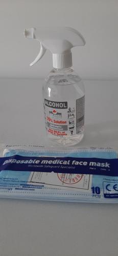 a bottle of alcohol next to a package of toothpaste at P.L Hermes Studios & Apartments in Larnaka