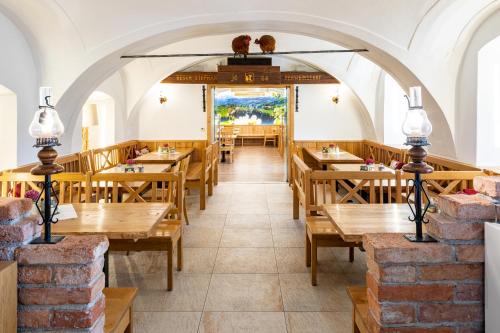 an empty restaurant with wooden tables and chairs at Perbersdorfer Heuriger in Neuhofen an der Ybbs