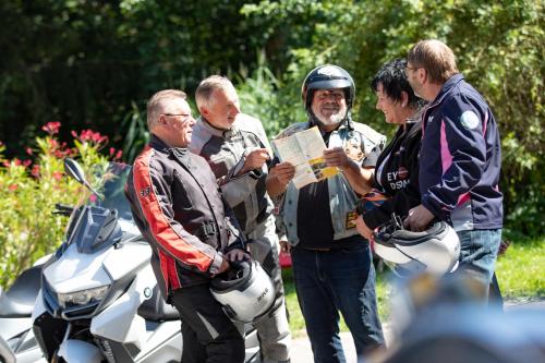 a group of men standing around a man with a motorcycle at Perbersdorfer Heuriger in Neuhofen an der Ybbs