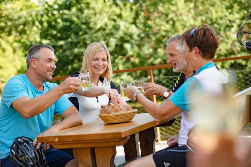a group of people sitting around a table drinking wine at Perbersdorfer Heuriger in Neuhofen an der Ybbs