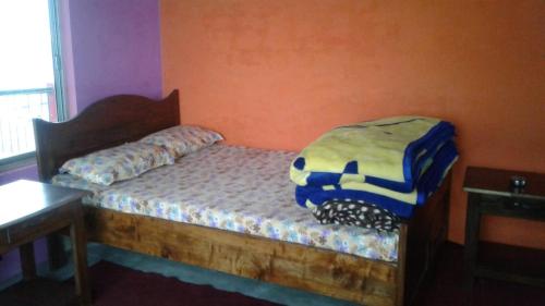 a bedroom with a bed with a blanket on it at Vamoose Heema Homestay in Ghum