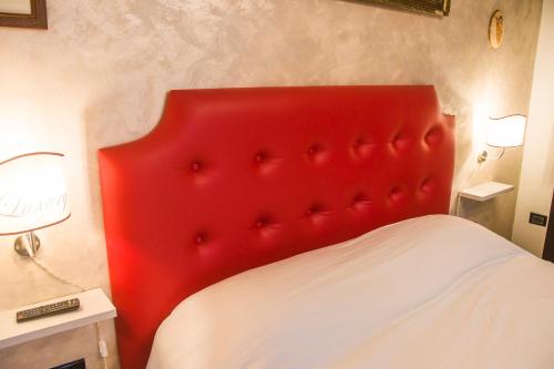 a red headboard of a bed in a bedroom at B&B Luxury in Lecce