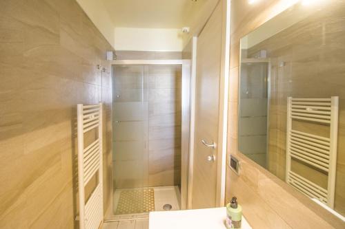a bathroom with a shower with a sink and a mirror at B&B Luxury in Lecce