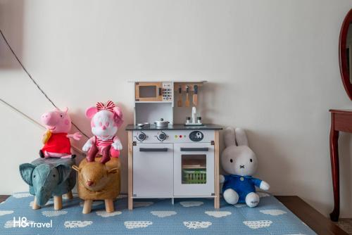 a toy kitchen with stuffed animals and a toy stove at Shan Tyi Homestay in Jian
