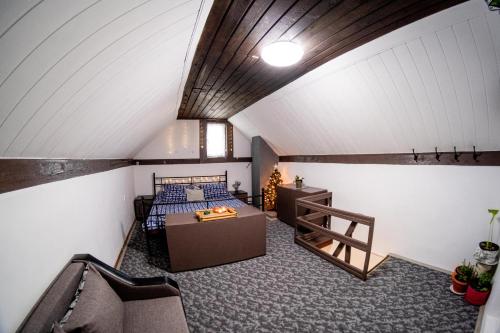 a attic room with a bed and a wooden ceiling at The Cosy Spot - Straja in Straja