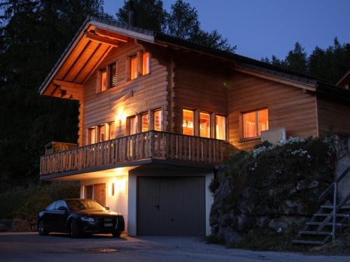 a house with a car parked in front of it at Chalet Mon Sousou in Nendaz