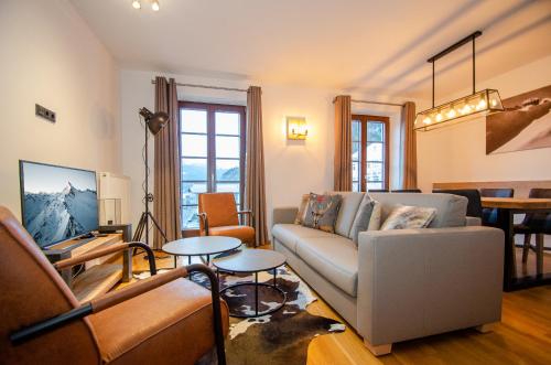 a living room with a couch and a table at Post Residence Apartments by All in One Apartments in Zell am See