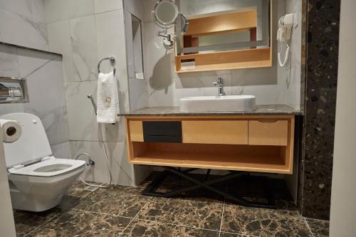 a bathroom with a sink and a toilet at The Quorum in Lusaka