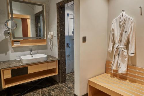 a bathroom with a sink and a mirror at The Quorum in Lusaka