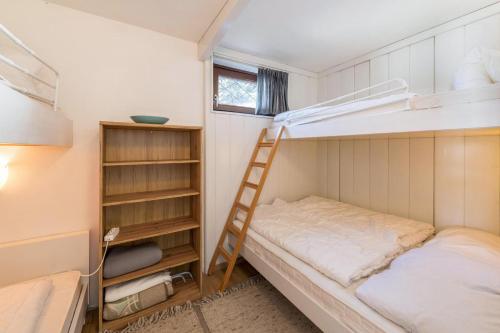 a small bedroom with a bunk bed and a ladder at Haus Steigerbauer - Top 1 in Königsleiten