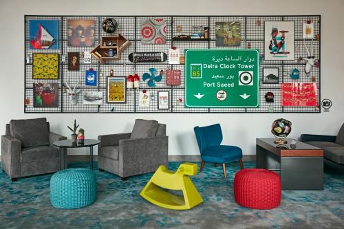 a waiting room with chairs and a sign on the wall at Rove City Centre, Deira in Dubai