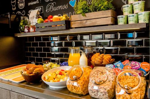 a buffet with many different types of food on a counter at Motel One Edinburgh-Royal in Edinburgh