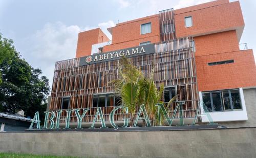 a brick building with a sign that reads a biryaniarma at Abhyagama Hotel in Digha