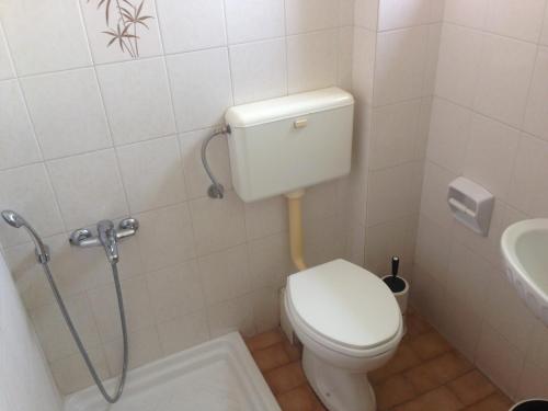 a bathroom with a toilet and a sink at Delimaras Studios in Nea Skioni