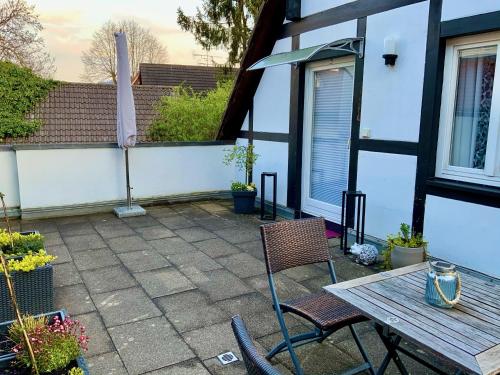 a patio with two chairs and a wooden table at Gasthaus Sonne in Vörstetten