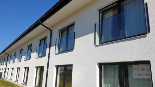 a building with windows on the side of it at TS Hotel by WMM Hotels in Siegsdorf