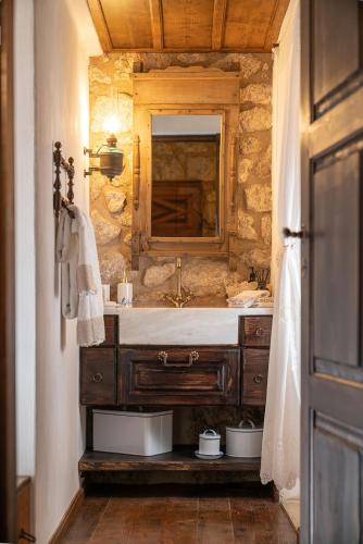 a bathroom with a sink and a mirror at 1813 Painters Stone Shelter in Galaxidhion