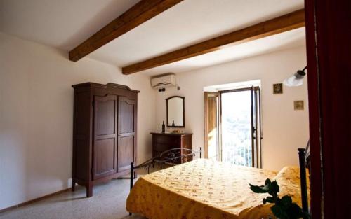 1 dormitorio con 1 cama, vestidor y ventana en One bedroom appartement with sea view shared pool and enclosed garden at Badolato, en Badolato
