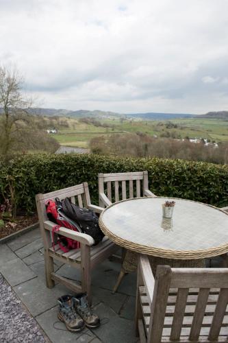 a table and two chairs with a table and a table and chairs with a view at Mason's Arms in Bowland Bridge