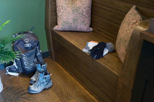 a pair of shoes and a backpack on the floor next to a bed at Mason's Arms in Bowland Bridge