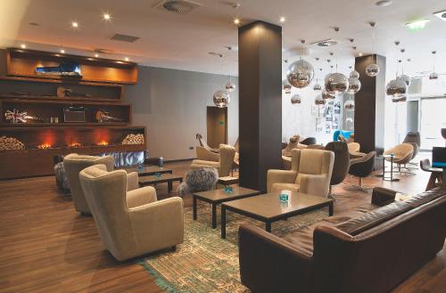 a living room filled with furniture and a tv at Motel One Manchester-Piccadilly in Manchester