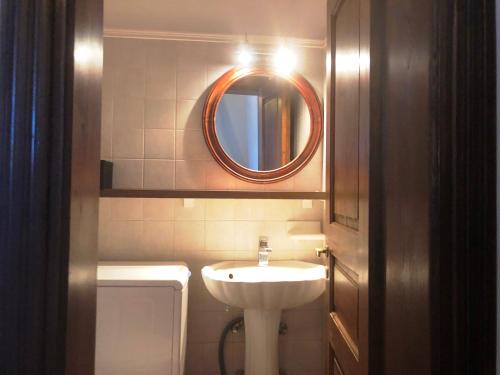 a bathroom with a sink and a mirror at Machi's House in Plaka Milou