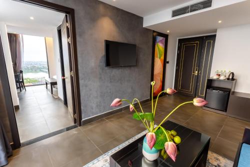 a living room with a couch and a table at White Lotus Hue Hotel in Hue