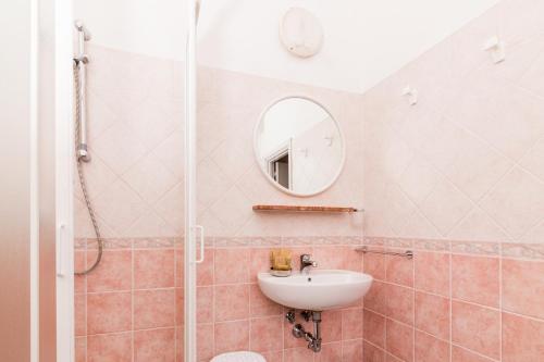 a bathroom with a sink and a mirror at Hotel Lydia in Cervia