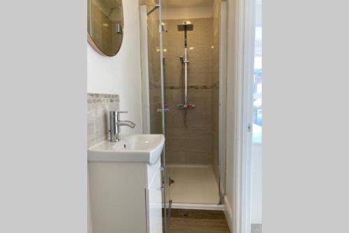 a bathroom with a shower and a sink and a shower at No43: Versatile 4BR coastal home with summer house in Cowes