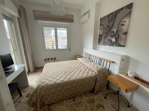 a bedroom with a bed and a desk and a television at Finestra sui Ponti in Ragusa
