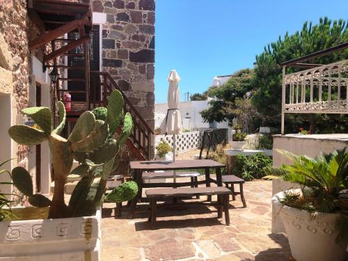 a patio with a picnic table and a cactus at Machi's House in Plaka Milou