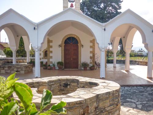 a church with a fountain in a courtyard at Zeus Traditional House in Mitrópolis
