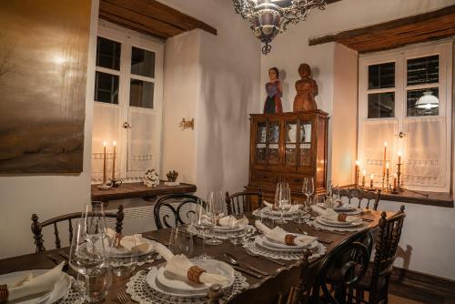 a dining room with a long table with chairs and a candlelit at The 1813 Painter's Villa by Neuvel in Galaxidhion