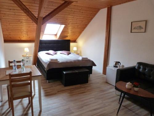 a bedroom with a bed and a living room at Penzion Stranny in Stranný